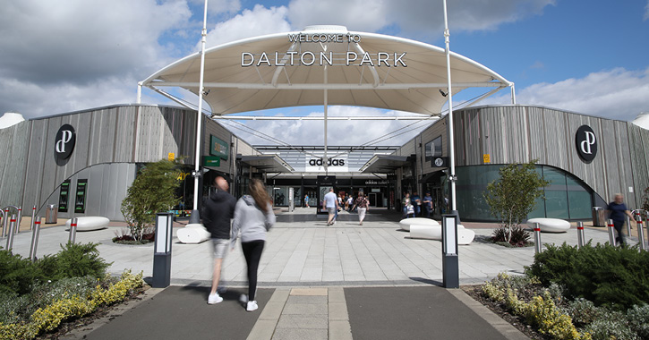 People walking into Dalton Park outlet shopping centre entrance